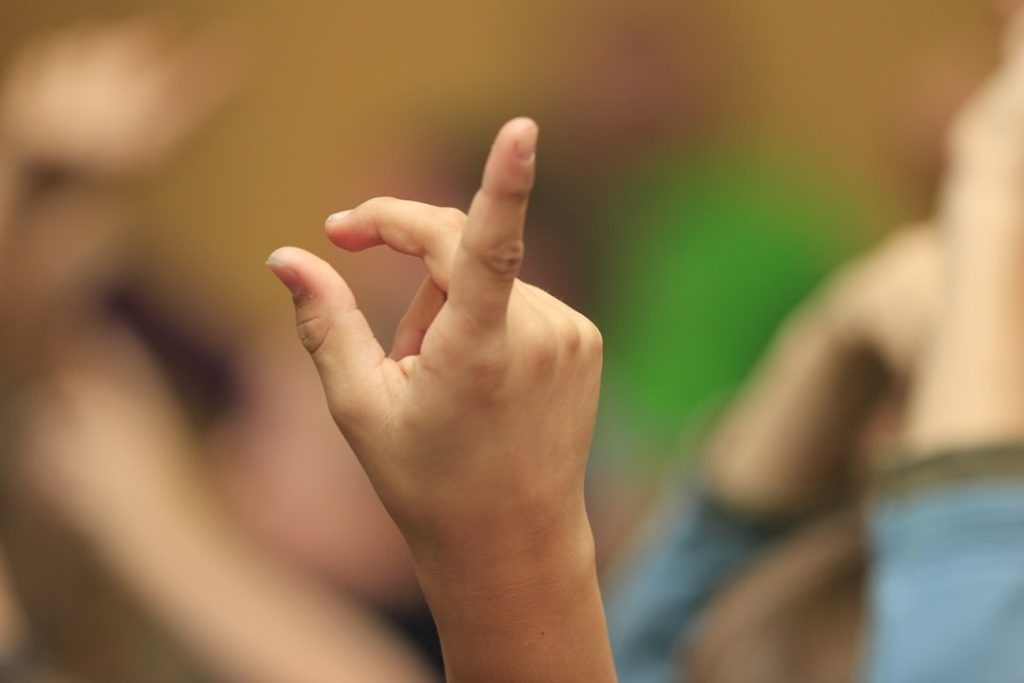 a-group-of-people-with-their-hands-in-the-air-akoq2o4tdye